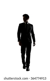 Confident businessman walking, silhouette portrait isolated
