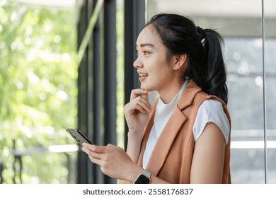 Confident Businesswoman Analyzing Stock Market Trends on Smartphone in Modern Office Setting - Powered by Shutterstock