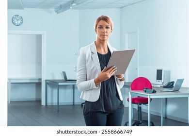 Confident businesswoman with a digital tablet in a modern office, embodying innovation and teamwork. Captures career potential and growth in the digital age - Powered by Shutterstock