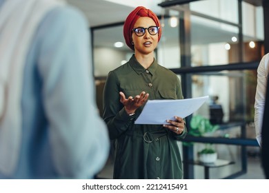 Confident Businesswoman Having A Meeting With Her Colleagues In A Modern Office. Muslim Business Manager Leading A Multicultural Team In An Inclusive Workplace.