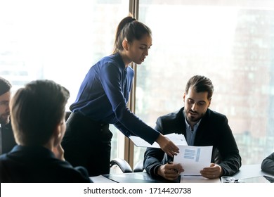 Confident businesswoman mentor giving papers, business strategy documents to employees at corporate meeting, handout material, leader boss presenting financial report, project plan - Shutterstock ID 1714420738