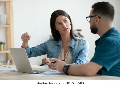 Confident businesswoman mentor teaching intern, working on online project, sitting at table with laptop in modern office, colleagues discussing strategy, sharing ideas, brainstorming at meeting - Shutterstock ID 1817935580