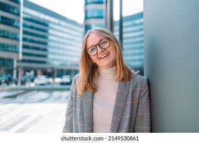 Confident Businesswoman Standing In Power Pose, Smiling At The Camera In Urban Background. Business People Concept