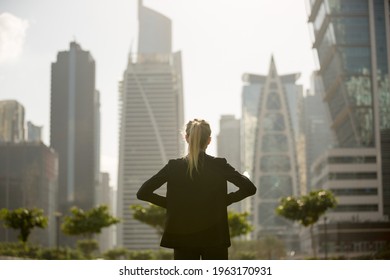 
Confident businesswoman standing strong looking at the city high-rises view. Business ambition and aspire.