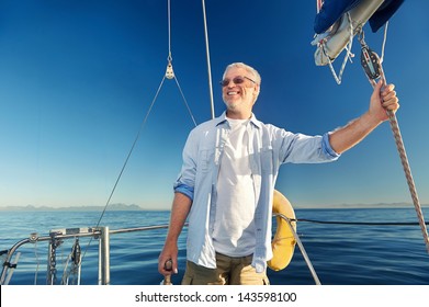 Confident Captain Of Sail Boat Standing And Looking Out To Sea