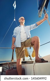 Confident Captain Of Sail Boat Standing And Looking Out To Sea