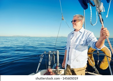 Confident Captain Of Sail Boat Standing And Looking Out To Sea