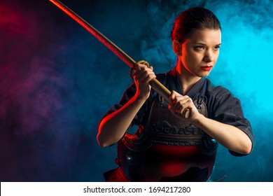 confident caucasian female kendo warrior with shinai in hands, woman training before competitions, japanese martial art