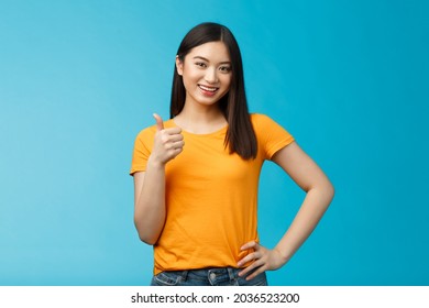 Confident Cheerful Asian Brunette Girl Show Thumb-up Satisfied, Give Approval, Liking Good Choice, Smiling Delighted, Accept Your Plan, Positive Judgement, Stand Blue Background