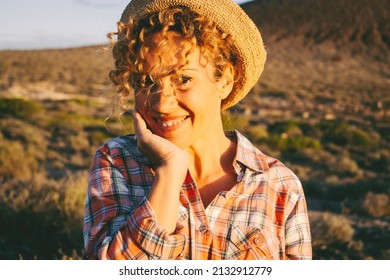 Confident And Cheerful Pretty Adult Female People Smile And Look At The Camera In Happy Expression Portrait. Mountains Outdoors Country Side In Background. Enjoyed Person. Cute Woman