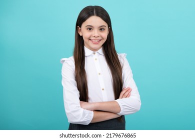 Confident Child Keep Arms Crossed, Isolated On Blue Background, Empty Space. Little Caucasian Teenage Girl 12, 13, 14 Years Old Hold Hands Crossed. Children Studio Portrait. Childhood Lifestyle.