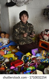 A Confident Child Salesman Is Selling Second Hand Toys - Mian Channu City - Punjab Pakistan - 2013