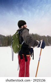 A Confident Cross Country Skiier Out On A Refreshing Trip Over A Frozen Lake With A Backpack