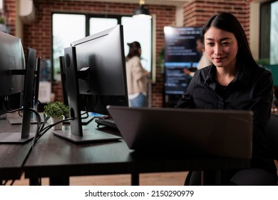 Confident Cyber Security Officer Accesing Administrator Rights By Bypassing Firewall Defence System. Asian Cybernetics Engineer Writing Lines Of Code In Order To Secure Mainframe Database Storage.