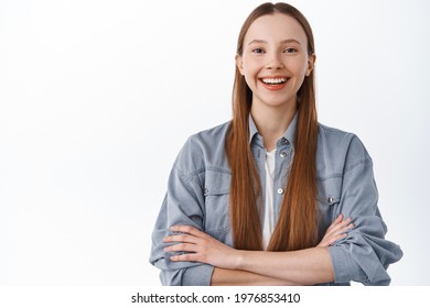 Confident And Determined Young Girl, Student Cross Arms On Chest Power Pose, Smiling And Looking Self-assured, Standing Over White Background Near Your Logo, Place For Banner