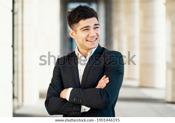 a confident director of the finance department.\
portrait of a man in a black business suit and white shirt looking\
at the camera. works in a bank in the city center. Dark-haired\
appearance. Sunlight.