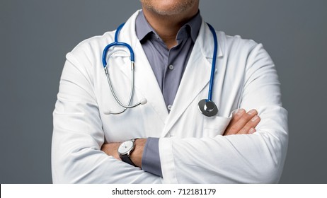 Confident doctor posing with arms crossed, medical advice and health insurance concept - Powered by Shutterstock