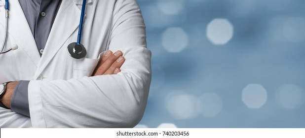 Confident doctor posing with arms crossed, medical advice and health insurance concept - Powered by Shutterstock