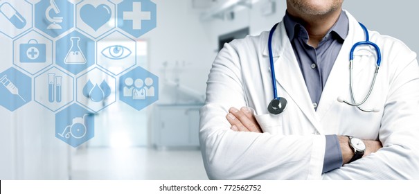 Confident doctor posing with arms crossed and medical icons interface, healthcare and technology concept - Shutterstock ID 772562752