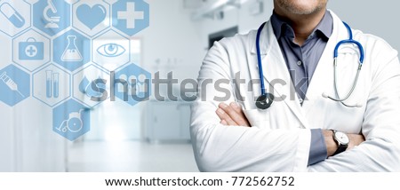 Confident doctor posing with arms crossed and medical icons interface, healthcare and technology concept