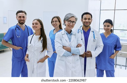 Confident doctors and nurses standing in modern hospital. Medical teamwork, international group of doctors - Powered by Shutterstock