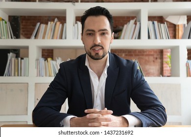 Confident eastern businessman entrepreneur in suit looking talking to camera, young ceo coach webinar speaker trainer recording vlog online business training make conference video call, webcam view - Shutterstock ID 1437231692