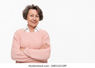 Confident elderly woman in smart casual clothes looking at the camera with arms crossed isolated over white background. Senior old grandmother businesswoman teacher closeup portrait - Powered by Shutterstock