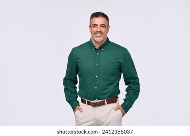 Confident elegant middle aged business man entrepreneur, smiling older professional executive, stylish businessman leader wearing green shirt looking at camera standing isolated on gray, portrait. - Powered by Shutterstock