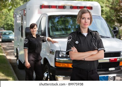 Confident Emergency Medical Team Portrait Standing With Ambulance In Background