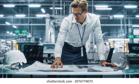 Confident Engineer in White Shirt Looking at a Technical Blueprint at Work in an Office at Car Assembly Plant. Industrial Specialist Working on Vehicle Parts in Technological Development Facility. - Shutterstock ID 2076774073