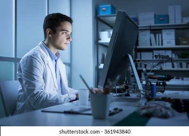 Confident Engineering Student Working In The Laboratory And Using A Computer, 3D Printer In The Background, Technology And Innovation Concept