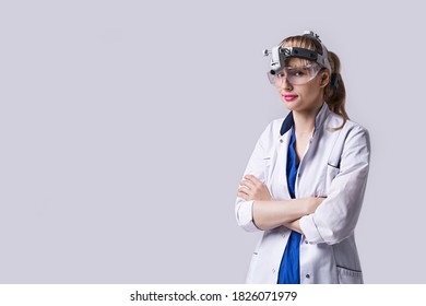 Confident ENT Doctor Surgical Headlight Head Light. Portrait Of Female Otolaryngologist Or Head And Neck Surgeon On Light Grey Background.