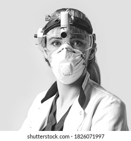 Confident ENT Doctor Surgical Headlight Head Light. Portrait Of Female Otolaryngologist Or Head And Neck Surgeon On Light Grey Background.