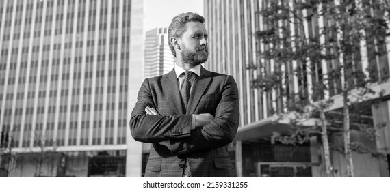confident entrepreneur in businesslike suit crossed hands outside the office, charisma
