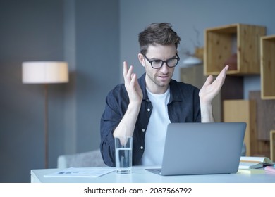 Confident European Businessman, Team Leader Conducts Video Conference Meeting On Laptop Sits At Home Office Works Remotely Online, Looking At Computer Screen While Gesticulating With Hands