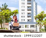 Confident experienced woman entrepreneur thinking about new work ideas while sitting with laptop computer outdoors