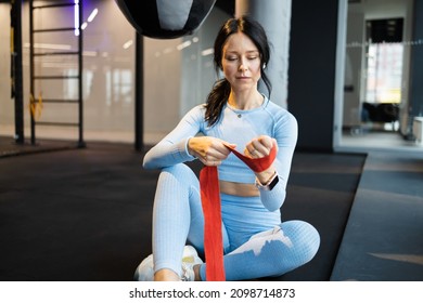 Confident Female Boxer Wearing Strap On Wrist