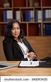 Confident Female CEO Sitting At Her Table