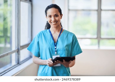 Confident Female Doctor in Hospital Corridor Holding Tablet - Powered by Shutterstock