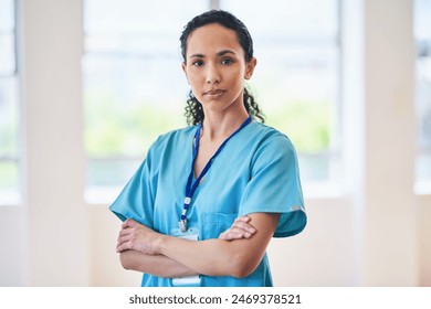 Confident Female Doctor in Hospital Setting Wearing Scrubs and ID Badge - Powered by Shutterstock