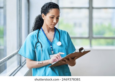 Confident Female Doctor Reviewing Patient Records in Modern Hospital - Powered by Shutterstock