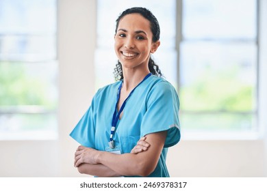 Confident Female Doctor Standing With Arms Crossed in Hospital - Powered by Shutterstock