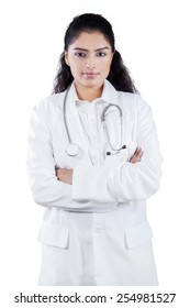 Confident female doctor wearing uniform and looking at the camera, isolated on white background