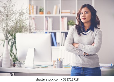 Confident Female Entrepreneur Standing In Her Office