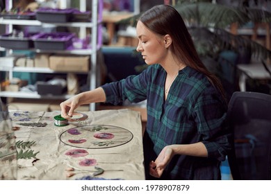 Confident Female Florist Is Working With Dryed Flowers In Cozy Flower Shop