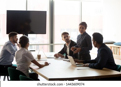 Confident Female Indian Manager Company Worker Lead Diverse Employees Group Meeting In Conference Room, Hindu Business Woman Team Leader Presenting Work Plan At Corporate Briefing At Boardroom Table