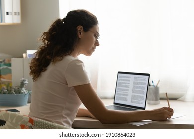 Confident female interpreter translate document from foreign language to english use pc app make notes in paper copy. Professional young woman editor correct errors mistakes in printed article text - Shutterstock ID 1910864023
