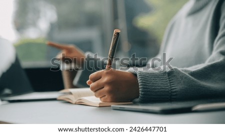Confident female interpreter translate document from foreign language to english use pc app make notes in paper copy. Professional young woman editor correct errors mistakes in printed article text