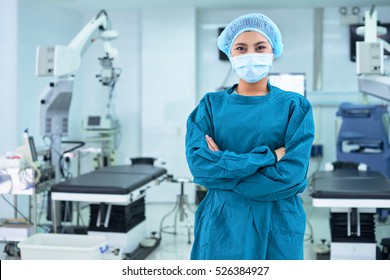 Confident female medical assistant standing in operating room - Shutterstock ID 526384927