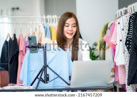 Confident female online retail seller presenting new arrivals of clothes to customers on social media, Online selling business concept.
